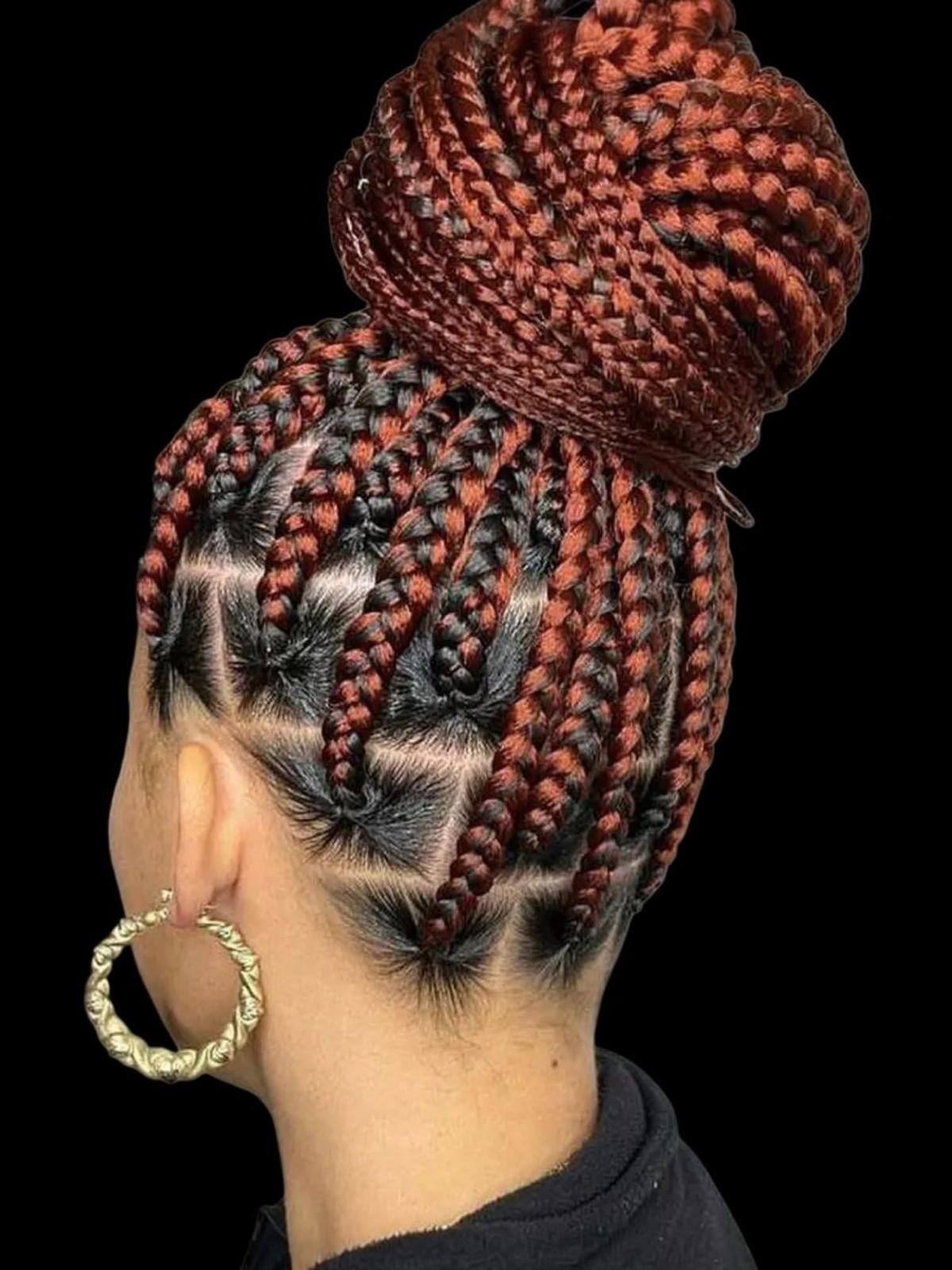 Burgundy box braids gathered into a high bun