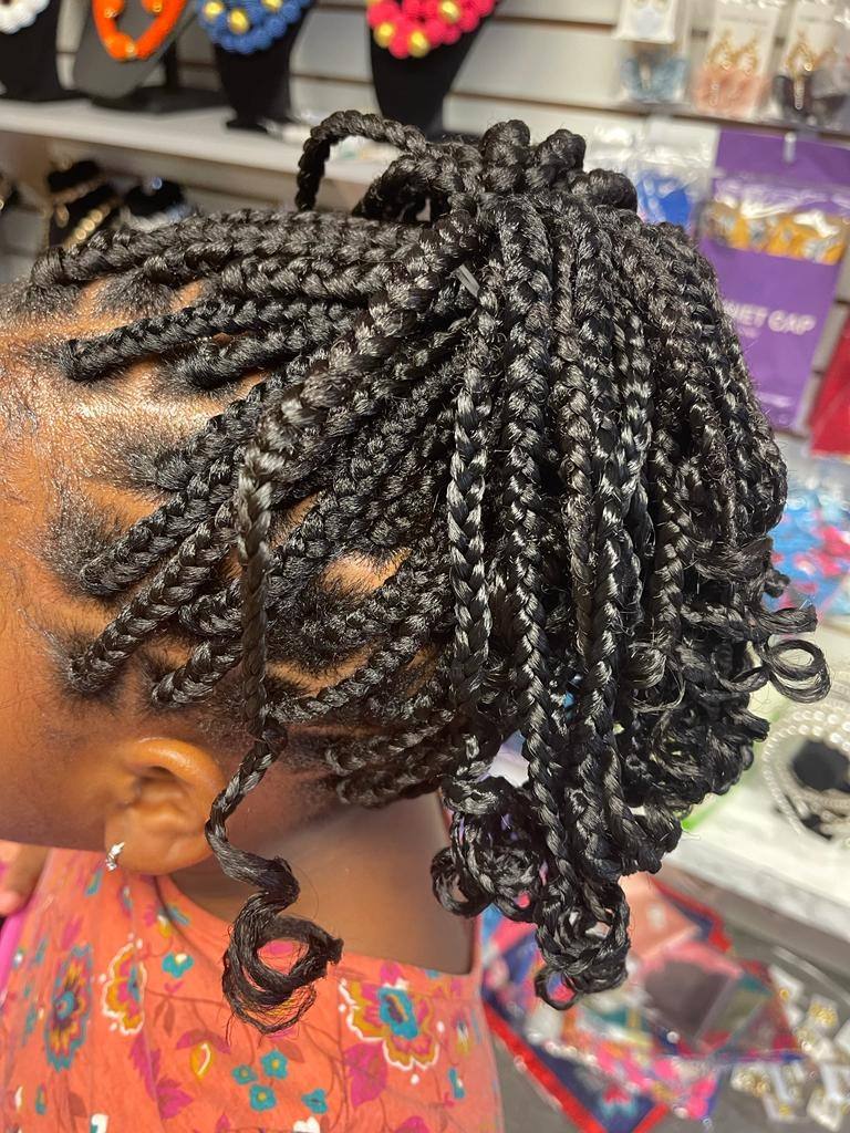 Child's box braids gathered into a playful updo