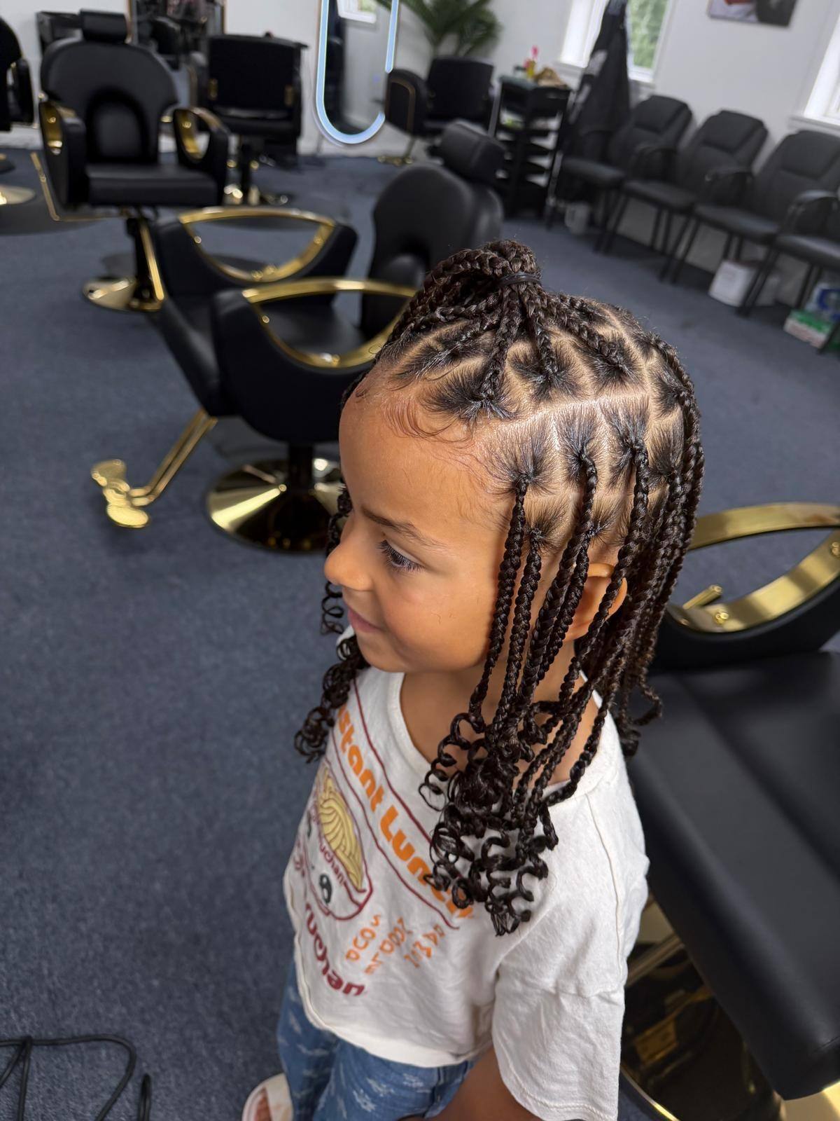 Young client's braids, side view in the salon chair