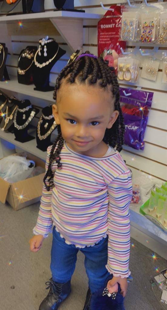 Toddler wearing neat cornrows finished with beads