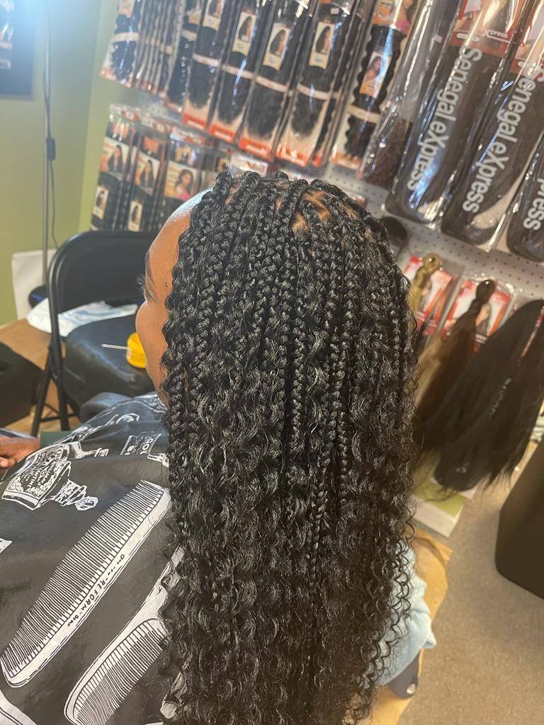 Knotless braids with curly tips viewed from the back