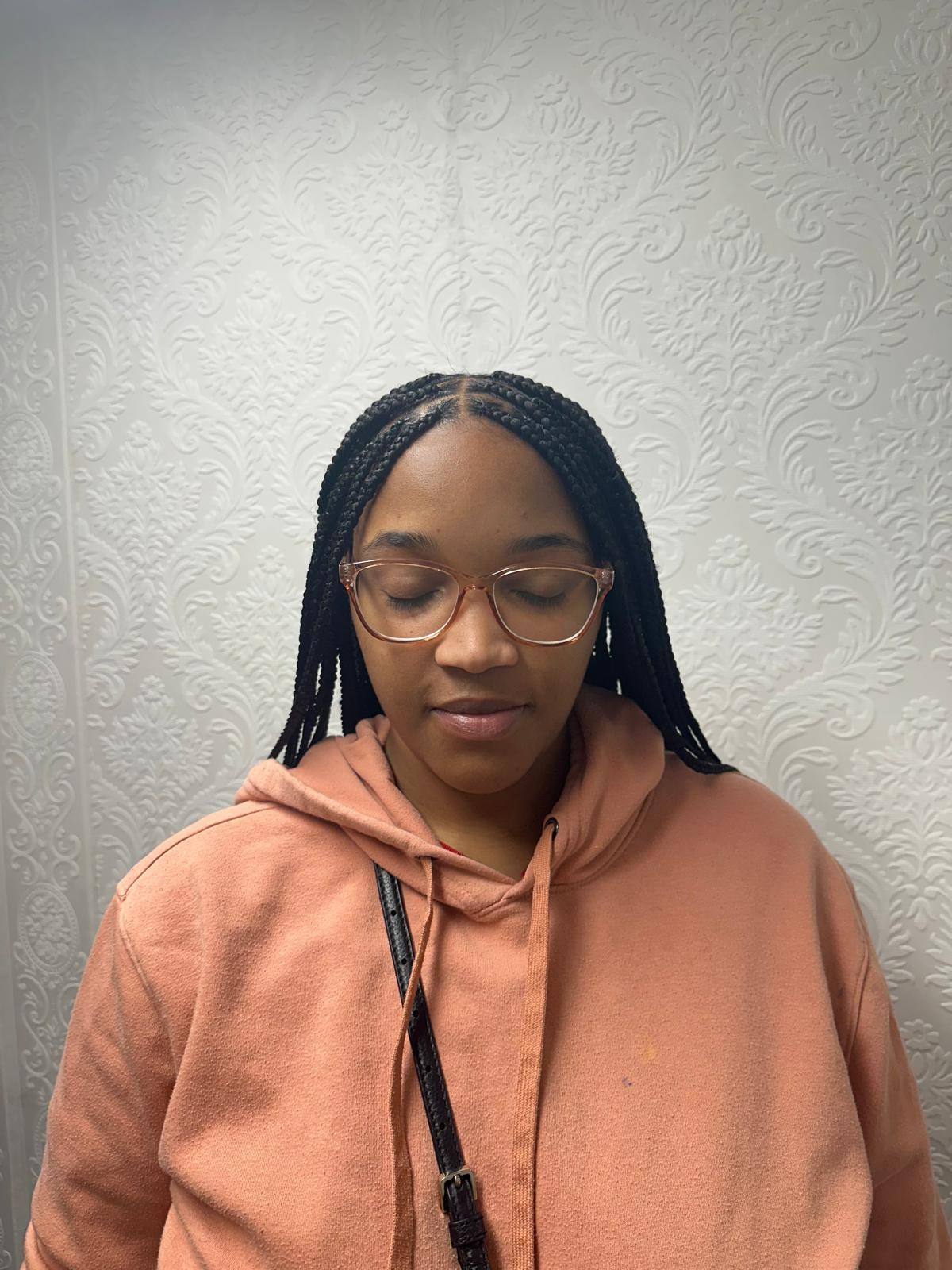 Client front view with freshly installed knotless braids