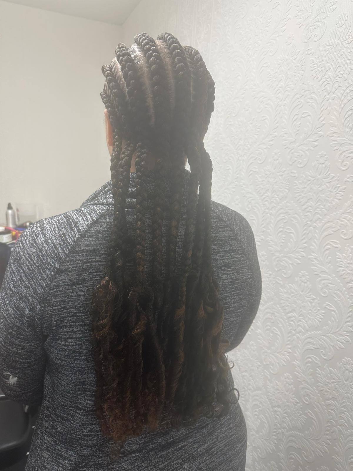 Knotless braids styled long, side view