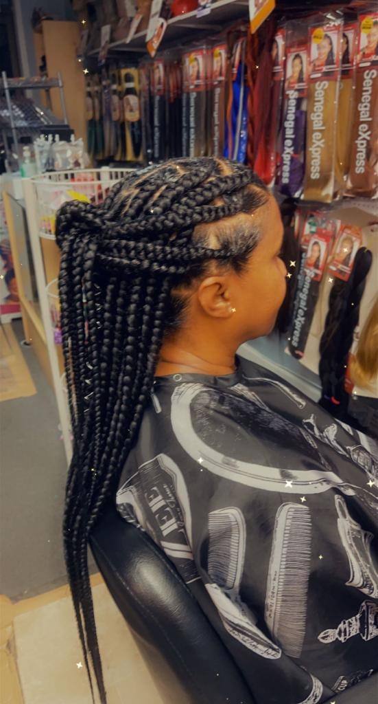 Small knotless braids styled waist length, side view in the Annandale salon chair
